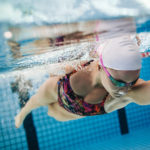 Young female swimmer swimming in pool